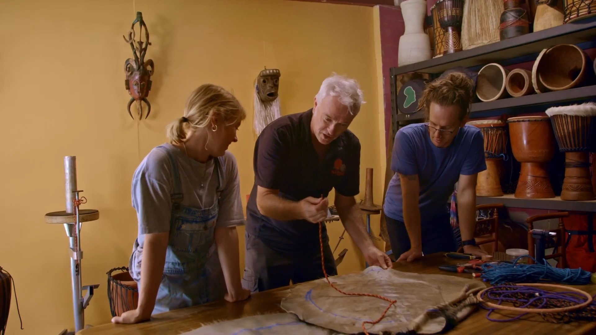 Drum Making Workshop with Elliott - instructing Bec Hoole and Alister Murray in 'threading the skin'.